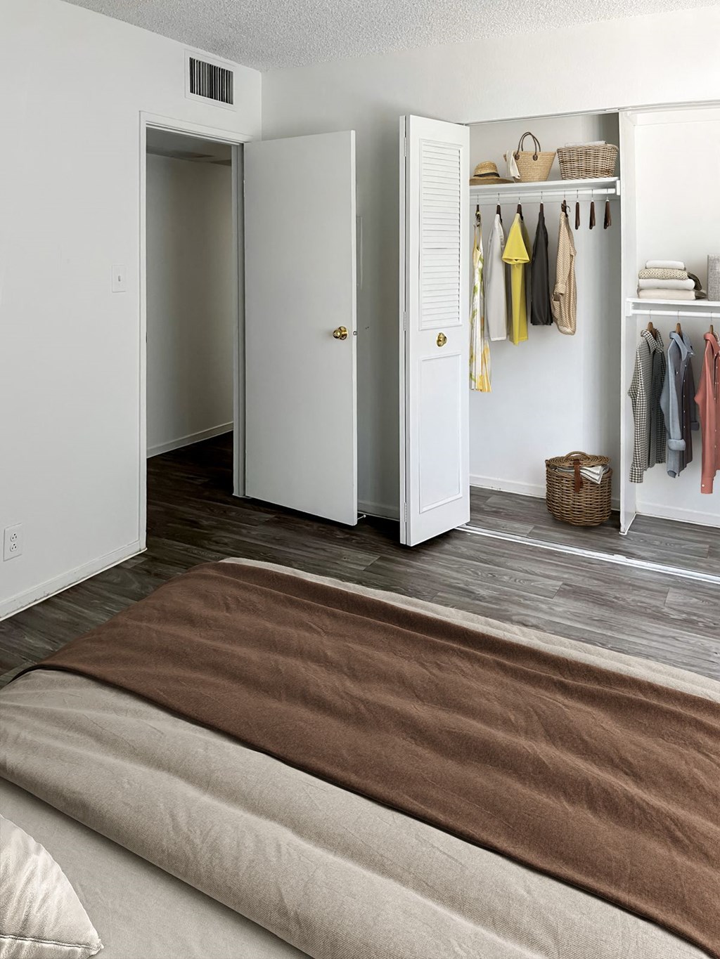 a living room with a couch and a closet at Evoq Apartment Homes, Las Vegas, NV 89169  