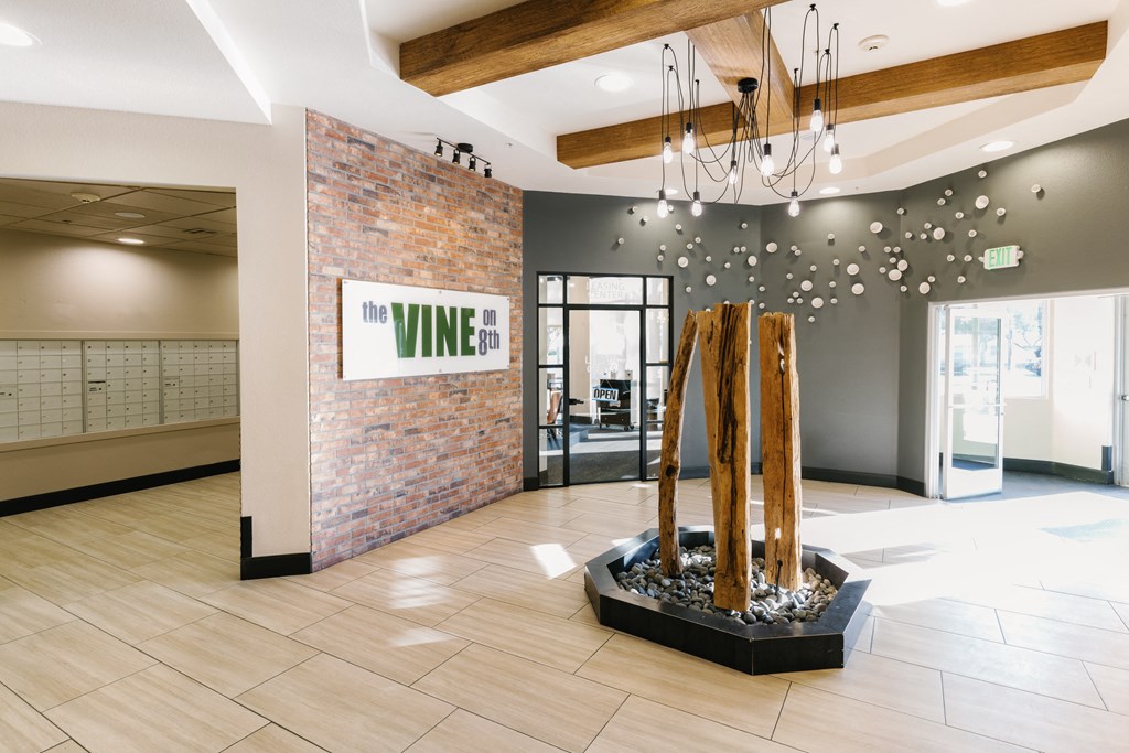a statue of a baseball bat in the lobby of a building