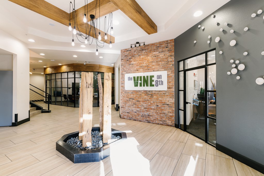 the lobby of the vine on walnut office building with a tree in the center