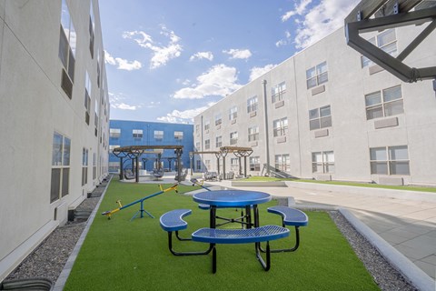 a playground and picnic area in the courtyard of an apartment building at The Onyx at 695, Reno, NV, 89503
