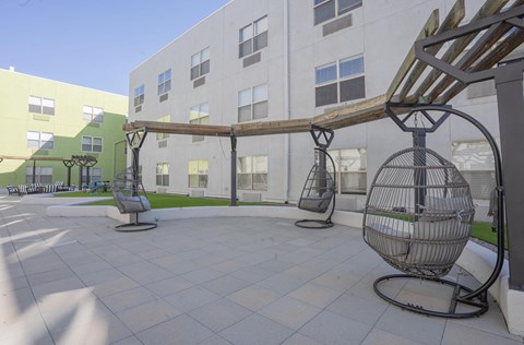 a courtyard with swing chairs in front of a building  at The Onyx at 695, Reno