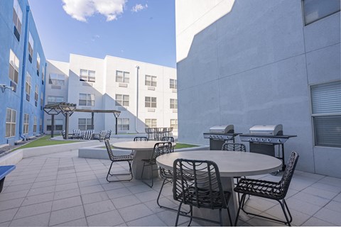 a patio with tables and chairs in a courtyard at The Onyx at 695, Reno, 89503