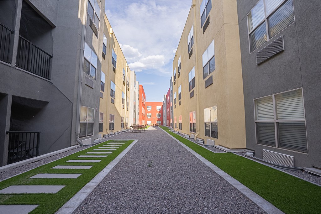a view of a courtyard between two apartment buildings with grass at ParcOne60, Reno, Nevada
