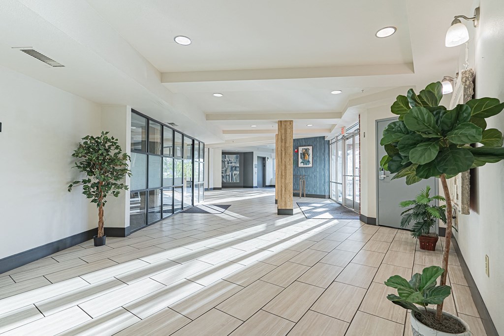 the lobby of a building with potted plants and glass doors at ParcOne60, Reno, 89501