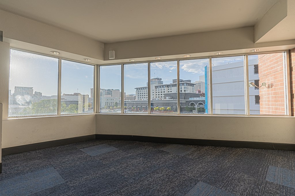 an empty living room with large windows and a city view at ParcOne60, Nevada, 89501