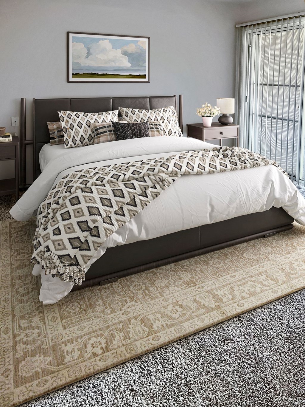 a bedroom with a large bed and a rug on the floor