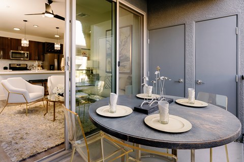 A modern dining room with a round table and chairs.