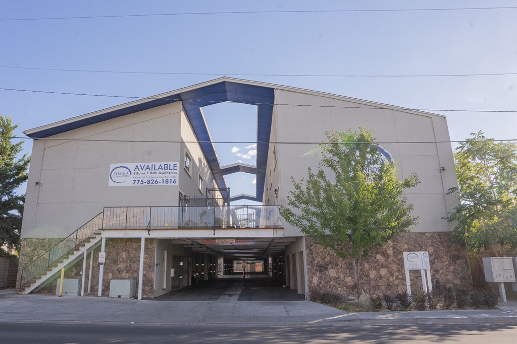 a large building with a bridge over a road
