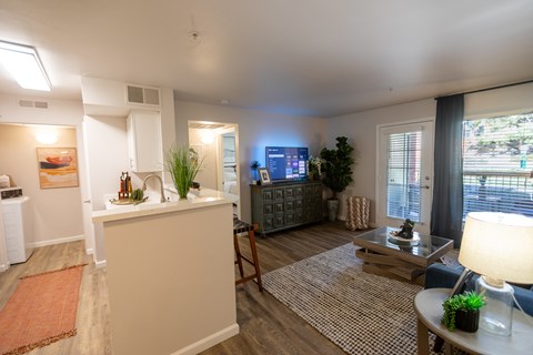 A living room with a white sofa and a wooden coffee table.