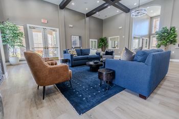 a living room with couches and chairs and a rug at Austin Crest Apartments, Reno, Nevada