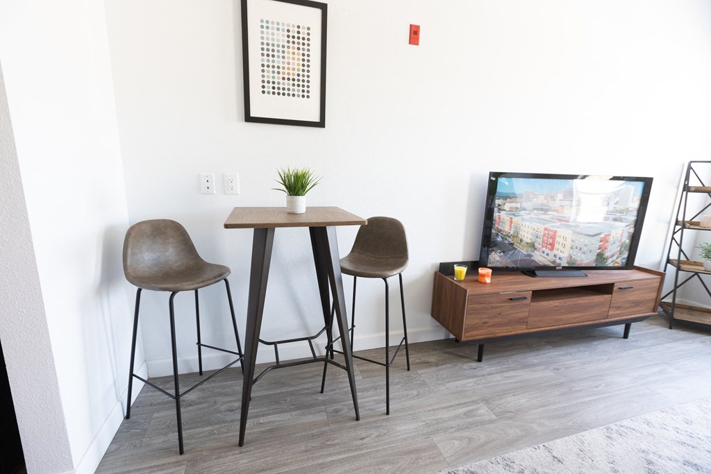 a living room with two stools and a table and a tv at ParcOne60, Nevada, 89501