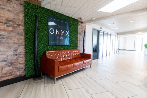 a living wall in an office lobby with a brown couch at The Onyx at 695, Reno, NV, 89503