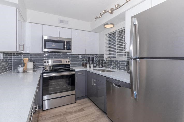 a kitchen with stainless steel appliances and a refrigerator at Evoq Apartment Homes, Nevada  