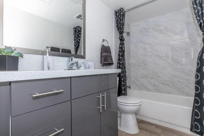 a bathroom with a toilet and a sink and a shower at Evoq Apartment Homes, Las Vegas Nevada  