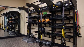 Spacious fitness center with cardio machines and weights at Tuscan Highlands, Nevada , 89141