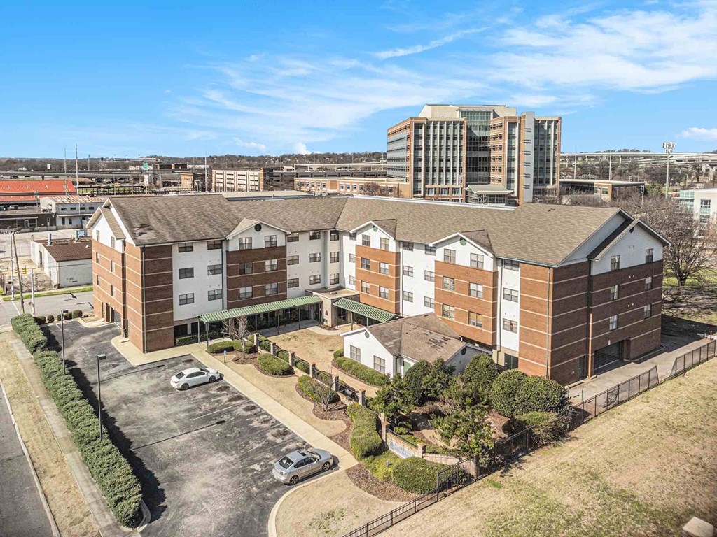 an aerial view of an apartment complex with a city in the background