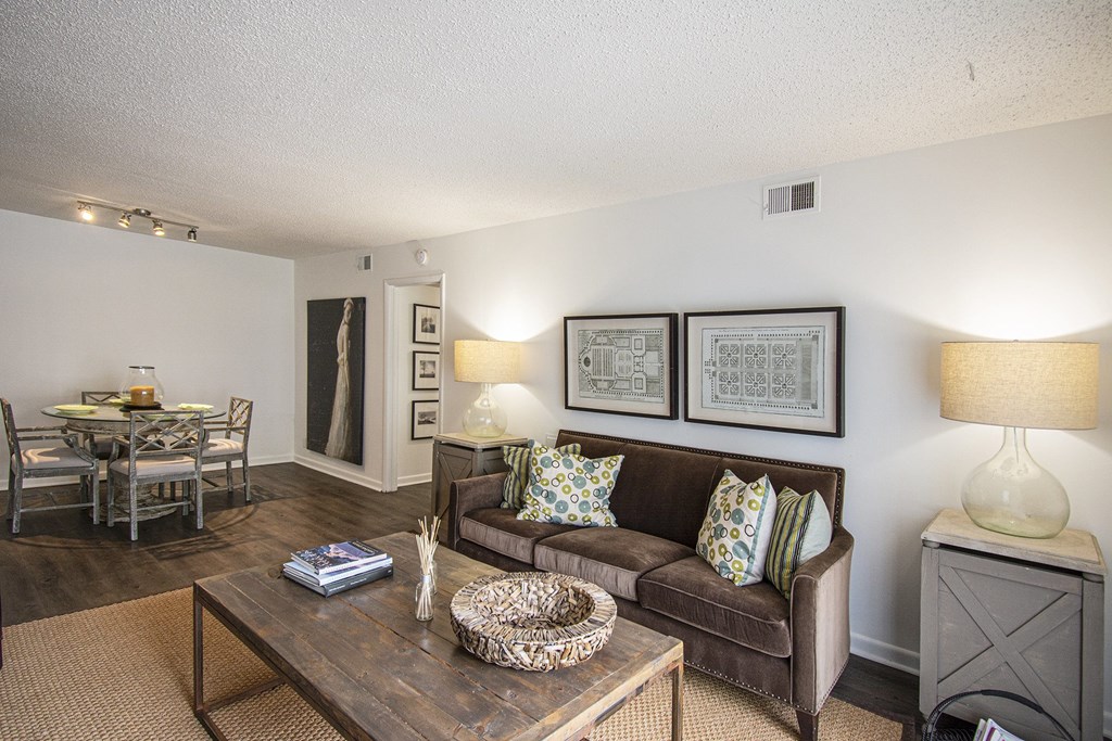 A living room with a brown couch and a coffee table.