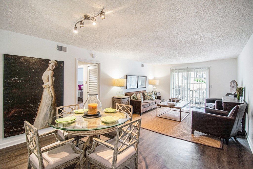 A living room with a glass table and chairs.