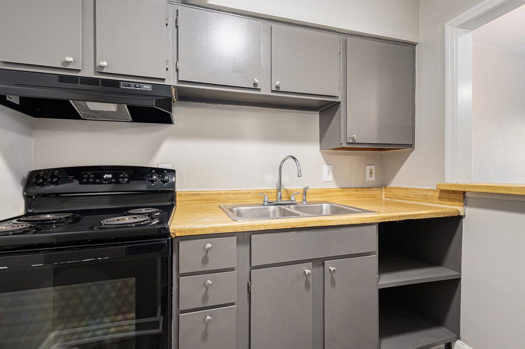 a kitchen with stainless steel appliances and a wooden counter top