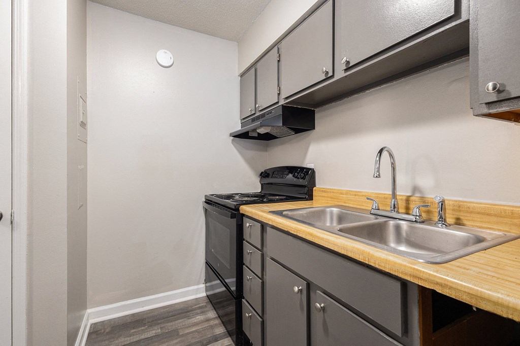 the kitchen of our studio apartment atrium with sink and stove