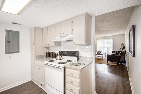 A kitchen with white appliances and cabinets.