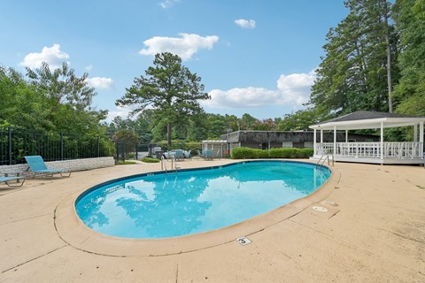 A small pool with a pavement around it.
