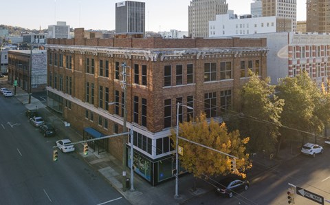 A street view of a city with cars and buildings.