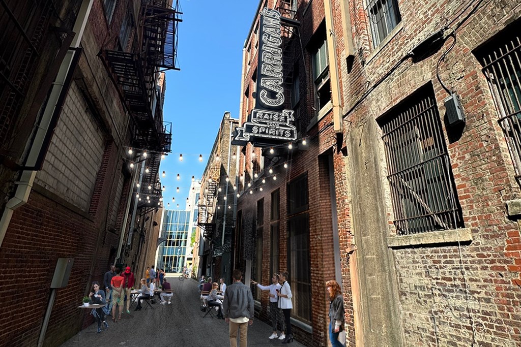 A narrow alley with people walking down it and a sign that says "Crafts".