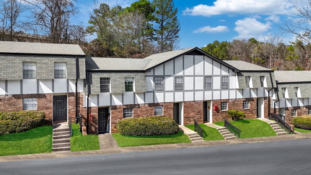 A row of houses with white and grey facades.