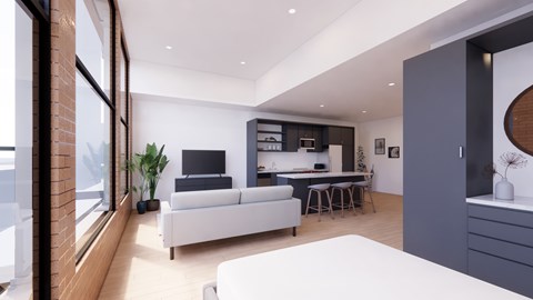 A modern living room with a white sofa and a grey kitchen area.