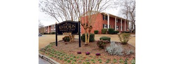 a building with a river run sign in front of it