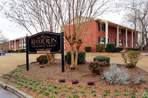 a building with a river run sign in front of it