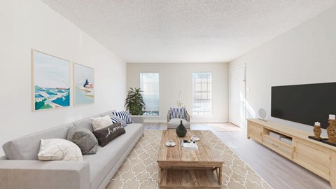 A living room with a grey couch, a wooden coffee table, and a large painting on the wall.