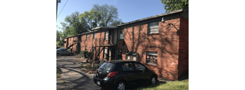 a car parked in front of a brick building