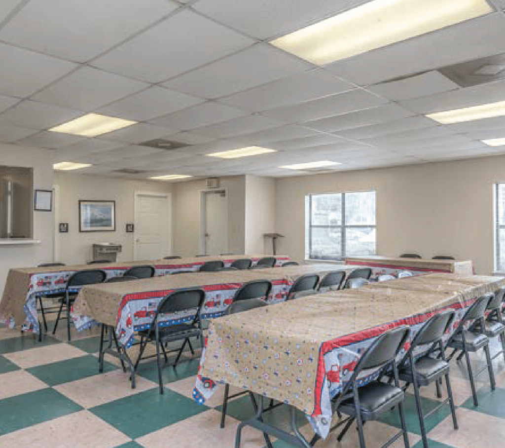 a conference room with tables and chairs in it