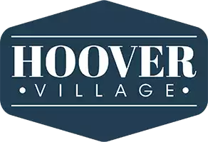 A logo with the text "Hoover Village" in white on a dark blue background.