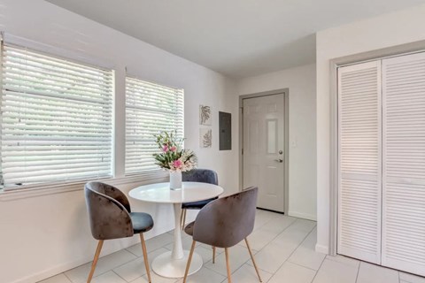 a dining room with a table and chairs