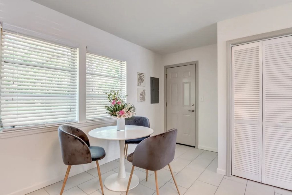 a dining room with a table and chairs