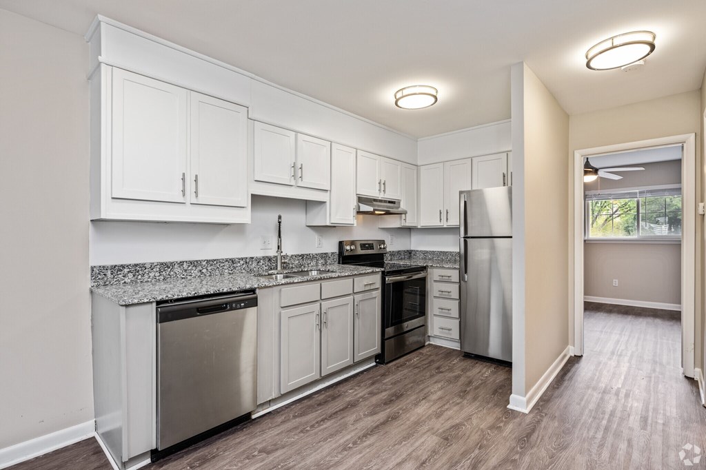 A kitchen with white cabinets and stainless steel appliances.