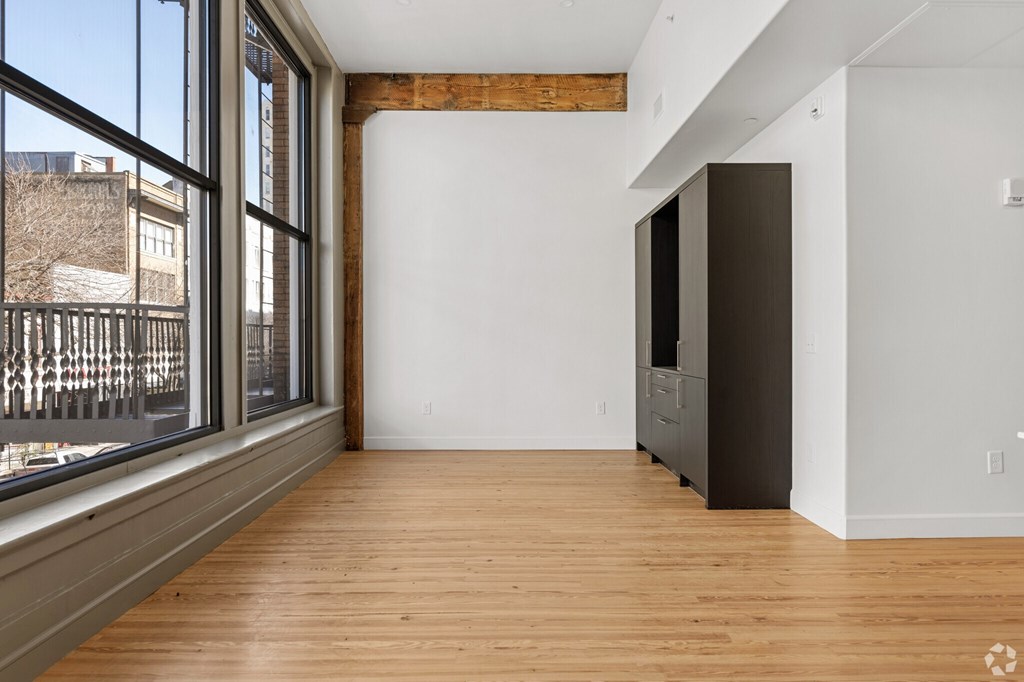 A room with a wooden floor and a large window.