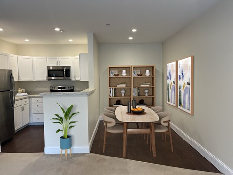 a kitchen and dining room with a table and chairs