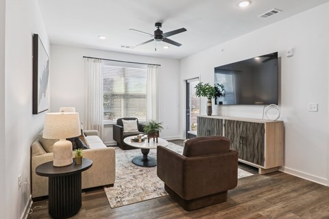 A living room with a brown chair and a black table.