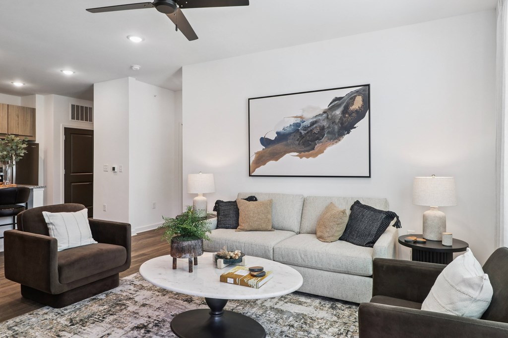 A living room with a couch, armchair, and coffee table.