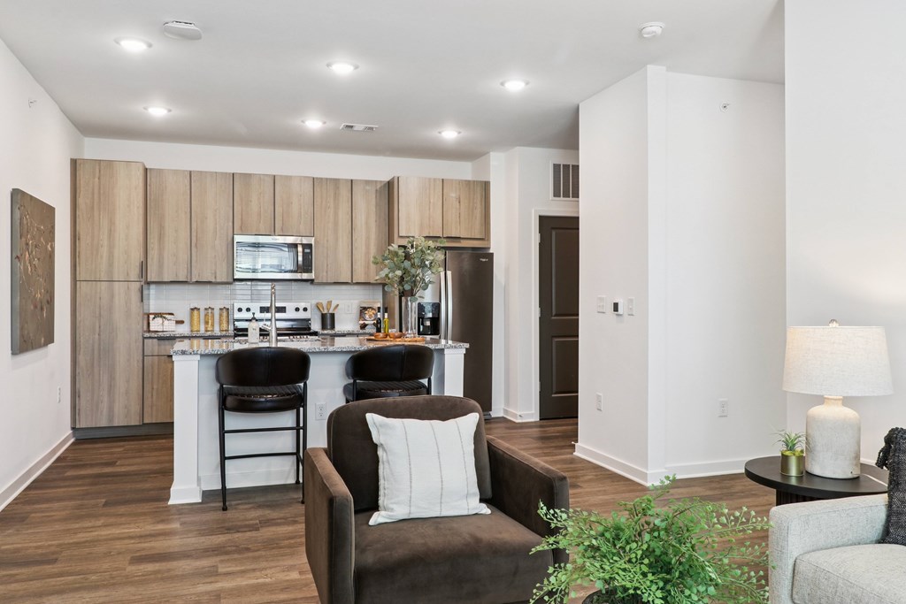 A modern kitchen with a dining area and a living room.