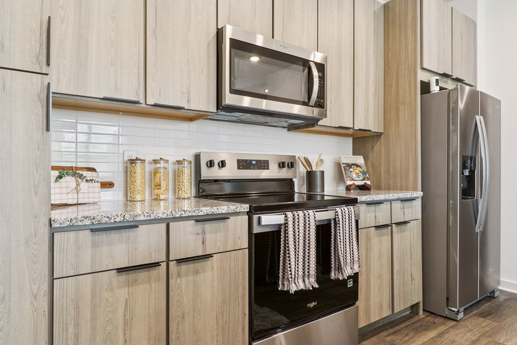 A modern kitchen with wooden cabinets and stainless steel appliances.