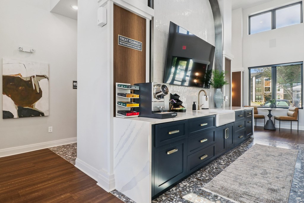 A modern kitchen with dark wood cabinets and a white countertop.