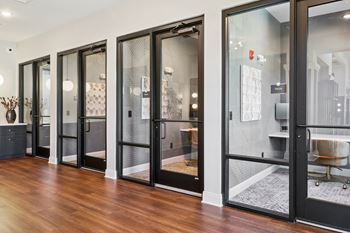 A hallway with a row of glass doors.