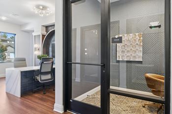A bathroom with a glass shower door and a towel hanging on the wall.