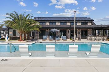 A pool with a building in the background.