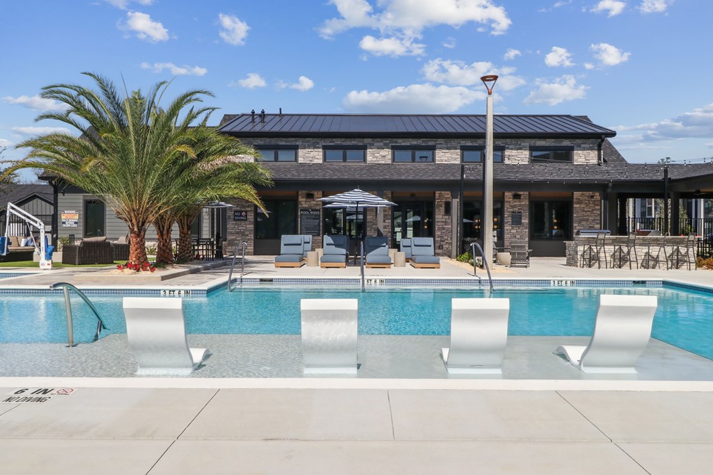 A pool with a building in the background.